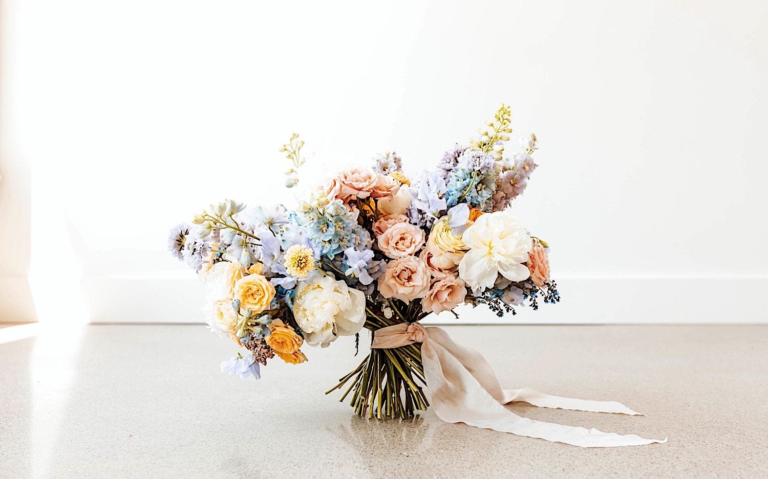 A large floral bouquet rests on the ground